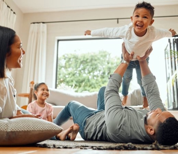 Happy mom, dad, son, and daughter